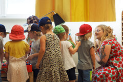 Eine Studentin spricht mit einer Gruppe Kindern.