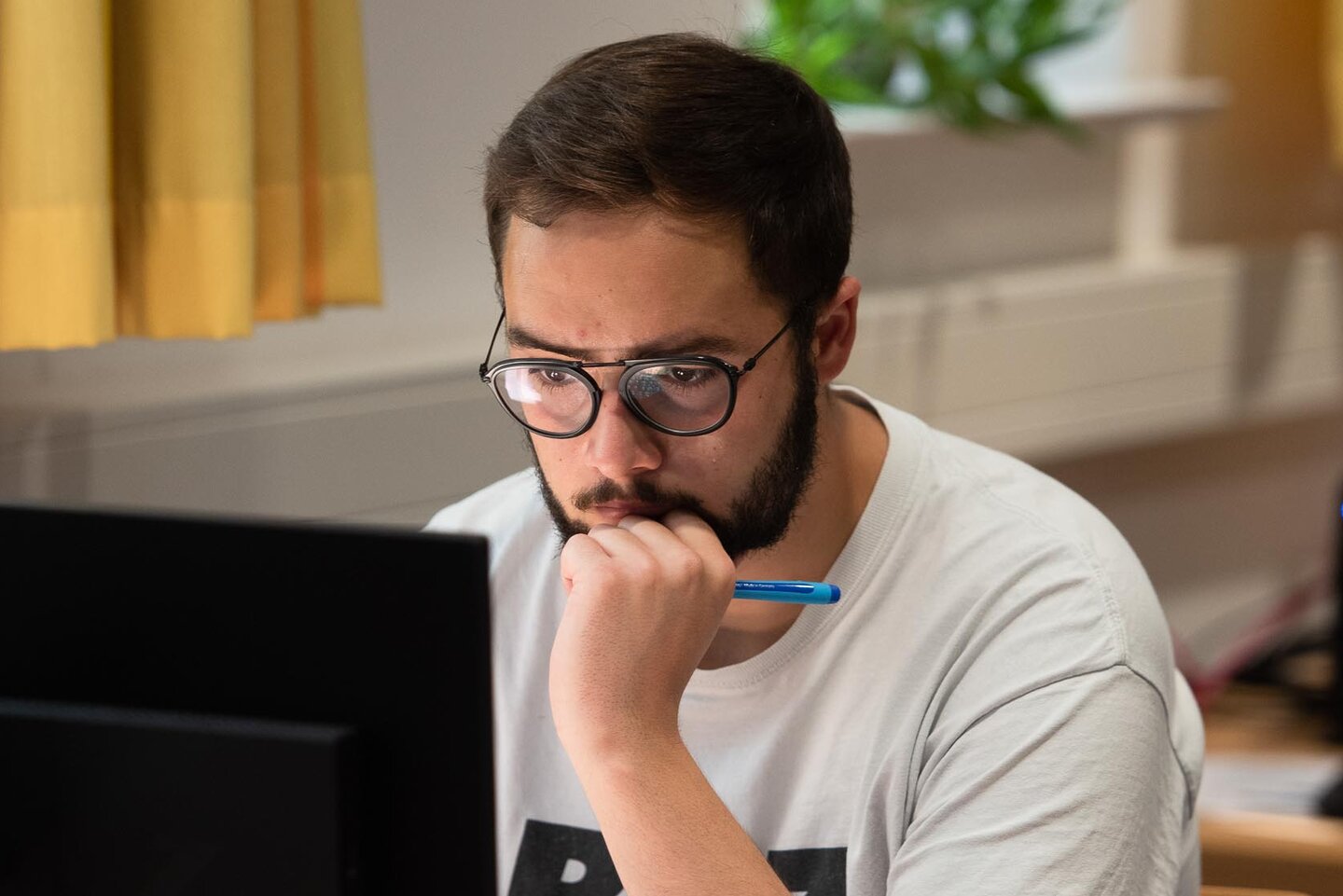 Student sitzt in der Bibliothek am Computer